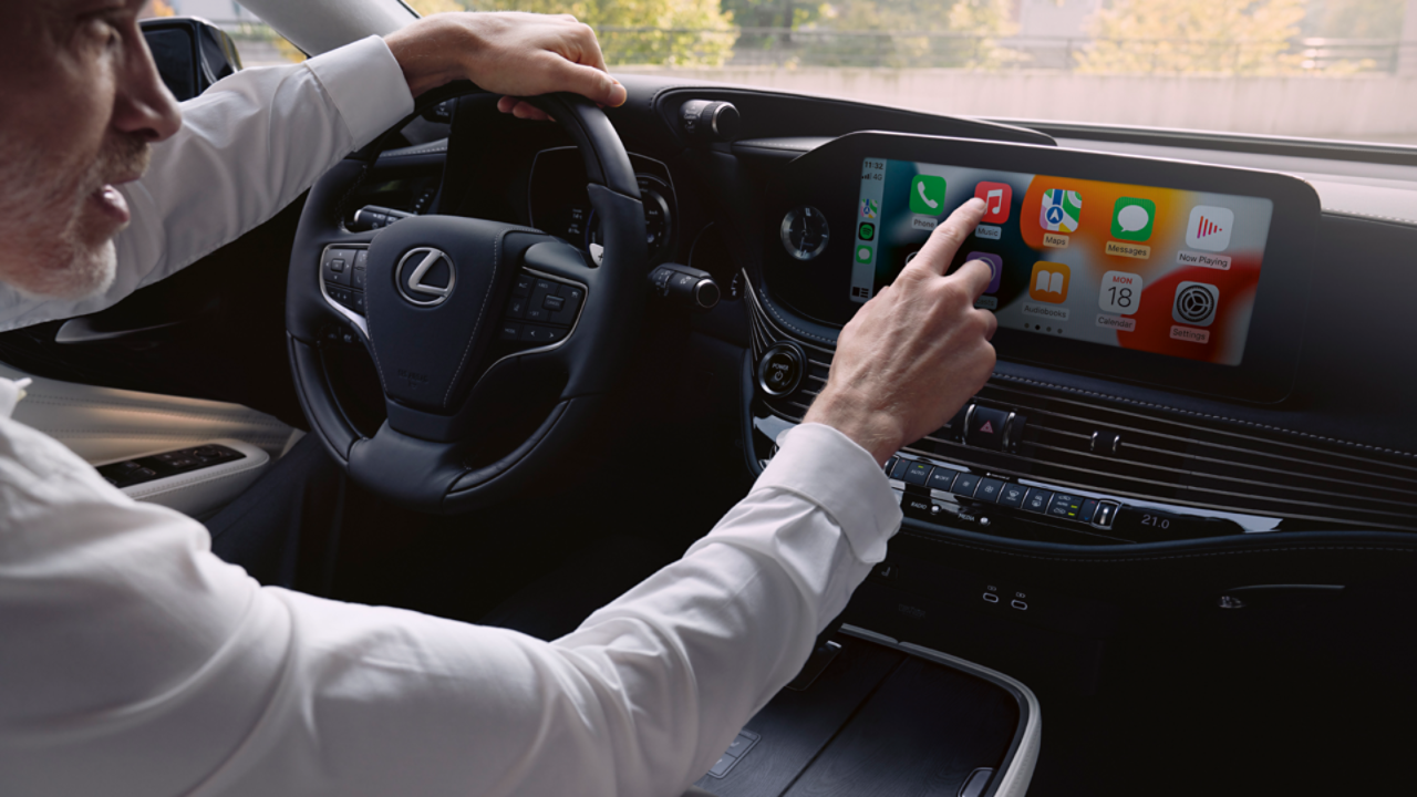 A person interacting with a Lexus multimedia display