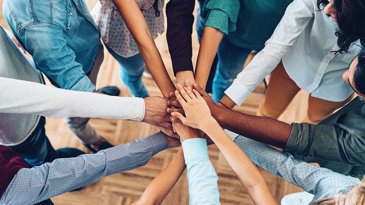 Business people with different nationalities joining their hands